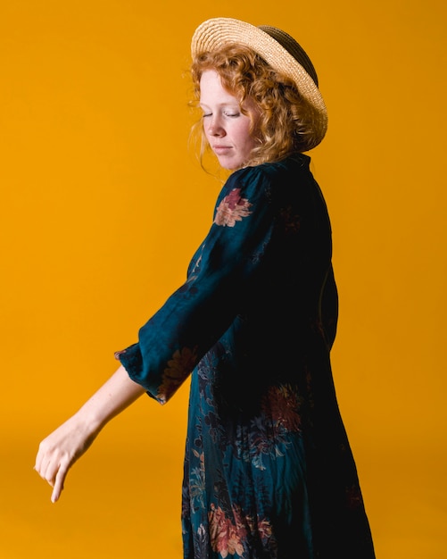 Ginger young woman posing and looking down