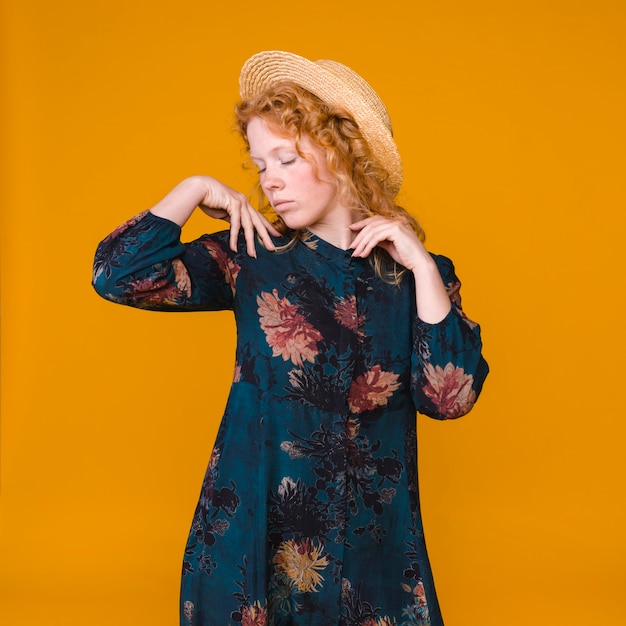 Ginger young woman posing with closed eyes