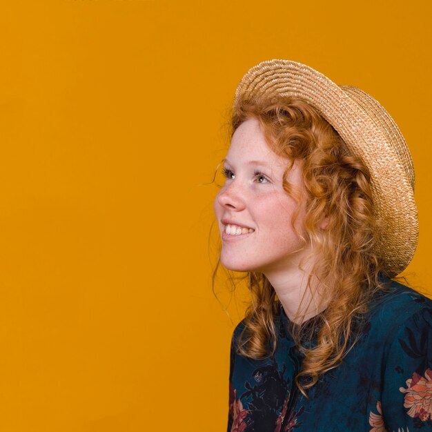 Ginger young woman smiling and looking away