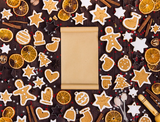 Free photo gingerbread cookies christmas empty paper for recipe new year oranges cinnamon