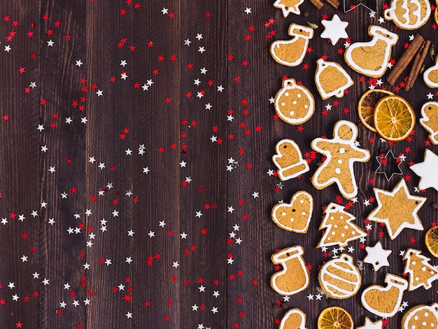 Gingerbread cookies christmas new year oranges cinnamon on wooden table