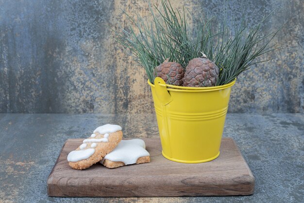 Gingerbread cookies and pinecones on wooden board. High quality photo