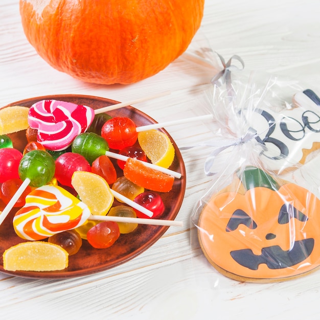 Gingerbread near plate with bonbons