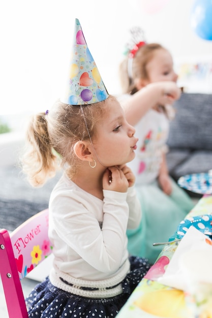 Girl adjusting party hat