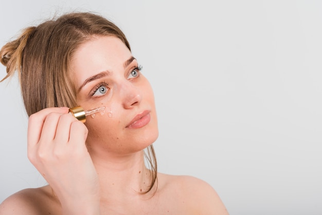 Girl applying herself cosmetic product