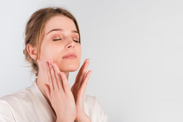 Free photo girl applying herself cosmetic product