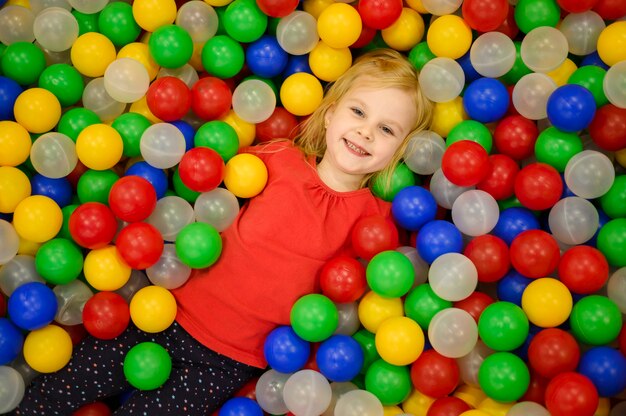 Girl in ball pit top view