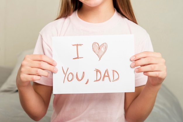 Girl on bed with paper for fathers day