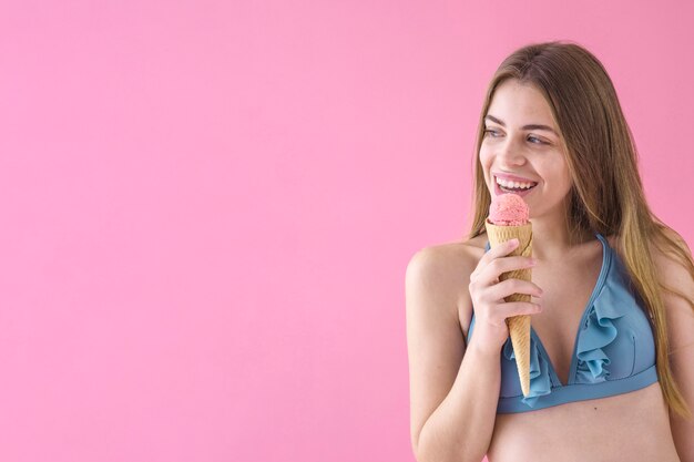 Girl in bikini with ice cream and copyspace