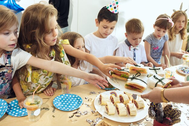 Girl birthday decorations. table setting with cakes, drinks and party gadgets.