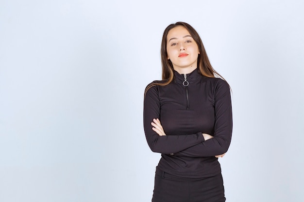 Girl in black clothes giving professional and neutral poses without reaction. 