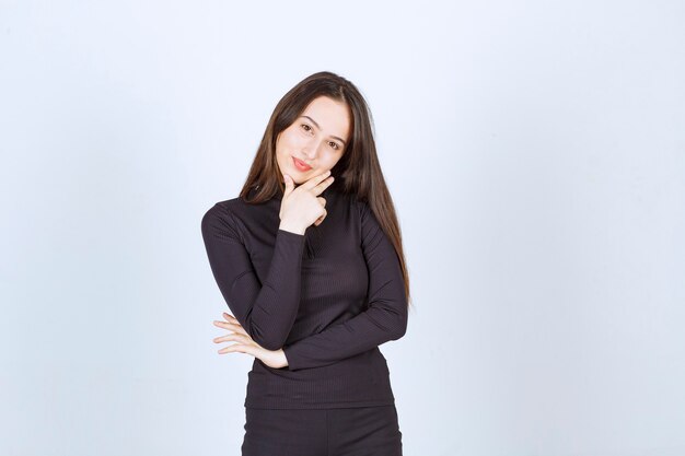 Girl in black clothes showing peace and friendship sign. 