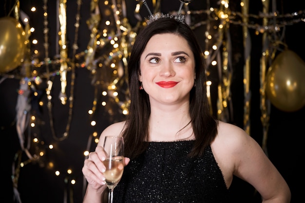 Girl in black dress at new year party