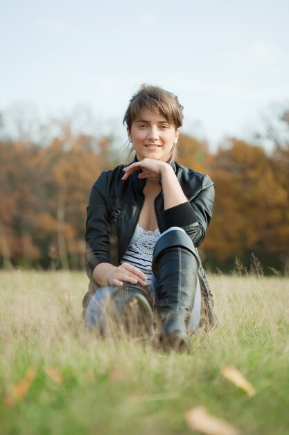 Girl in black high shoes at autumn