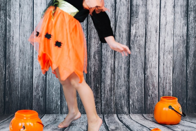 Girl in black and orange dress dancing