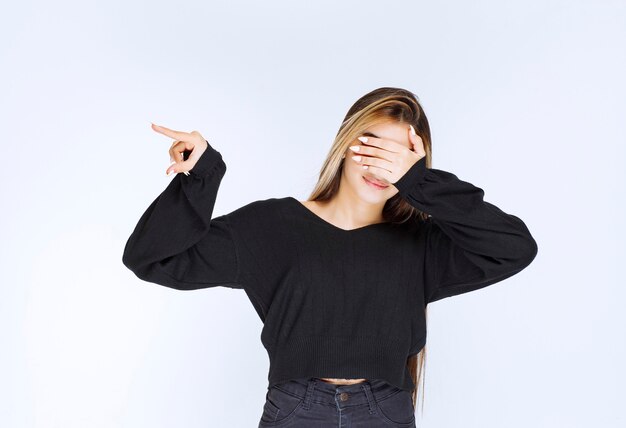 Girl in black shirt closing her eyes and slepping.