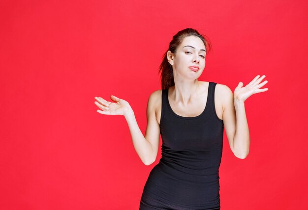 Girl in black shirt feeling positive and smiling gently. High quality photo