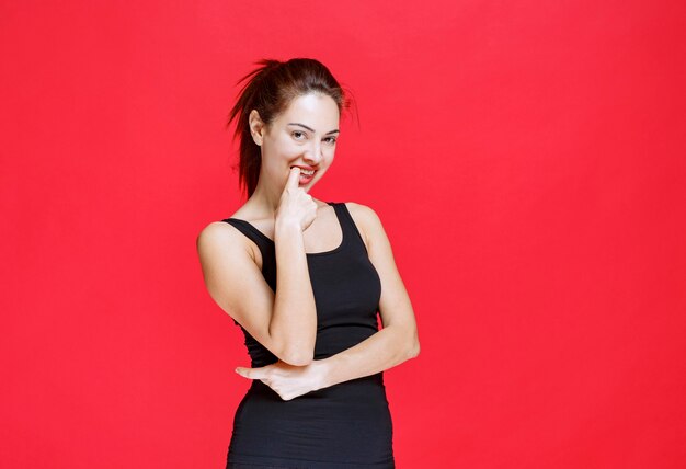 Girl in black shirt giving seductive and appealing poses. High quality photo