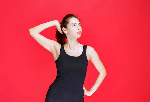 Girl in black shirt giving seductive and appealing poses. High quality photo