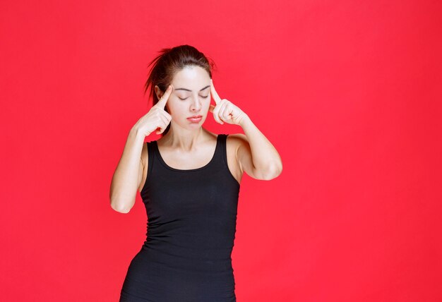 Girl in black shirt is tired and sleepy. High quality photo