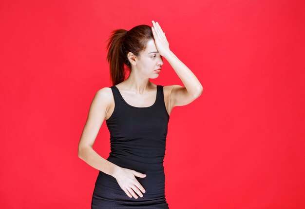 Girl in black shirt is tired and sleepy. High quality photo