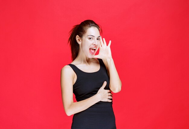 Girl in black shirt laughing out loud as a fool. High quality photo