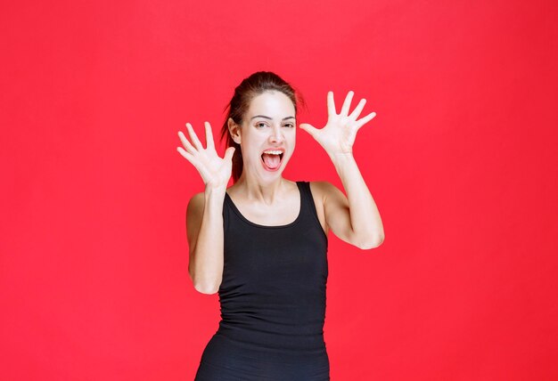 Girl in black shirt laughing out loud as a fool. High quality photo