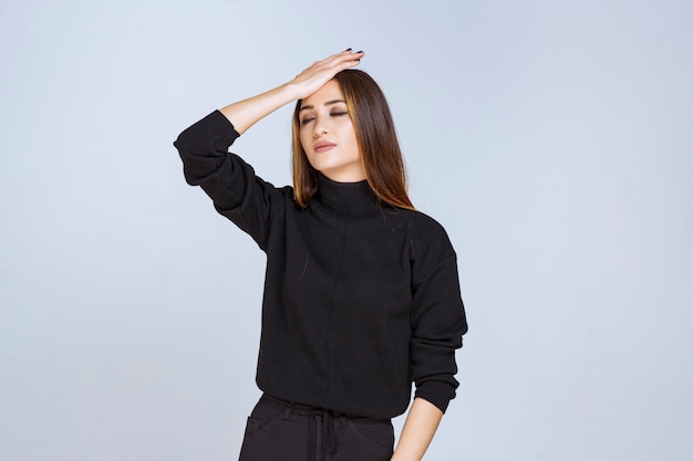 Girl in black shirt looks exhausted and sleepy. High quality photo