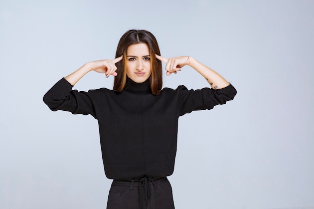 Girl in black shirt looks thoughtful. High quality photo