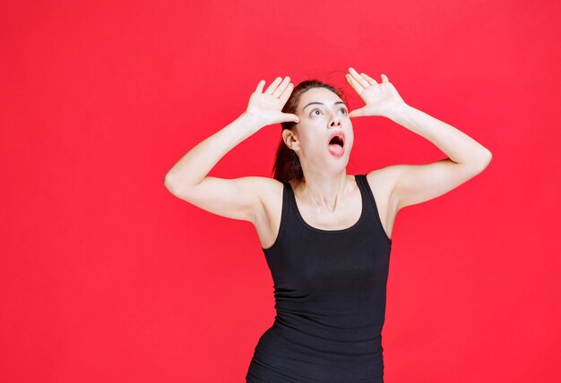 Girl in black shirt trying to stop danger coming to her. High quality photo