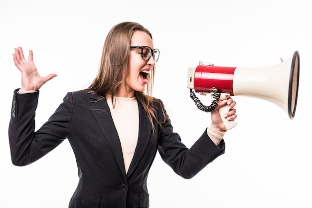 Girl in black suite screaming on a megaphone isolated over white