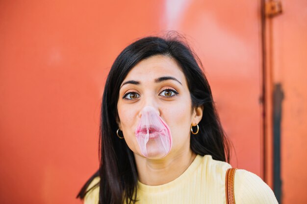 Girl blowing a bubble gum