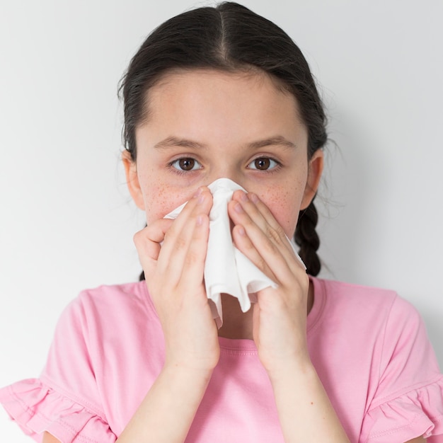 Girl blowing her nose