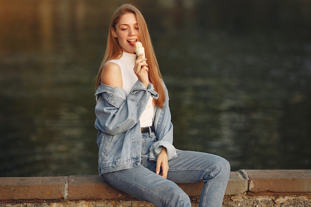 Free photo girl in a blue jeans jacket in a summer city