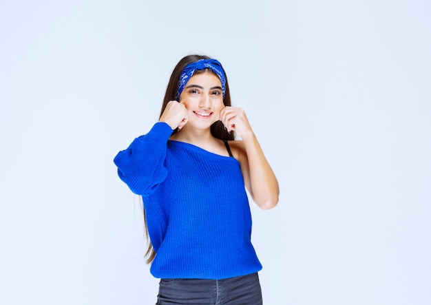 Girl in blue shirt giving seductive and cheerful poses.