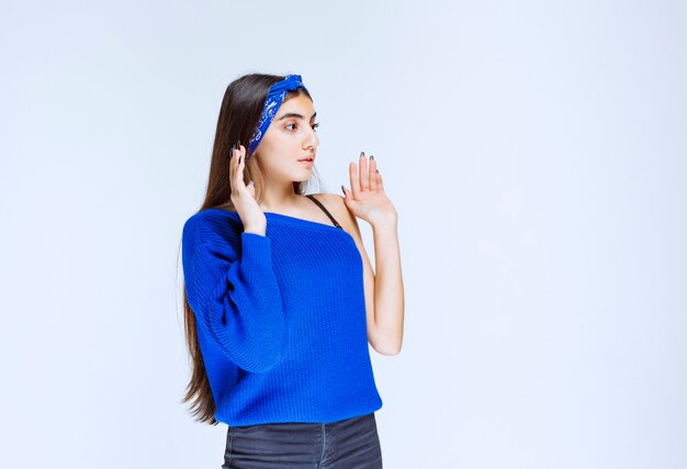 Girl in blue shirt looks scared and terrified.