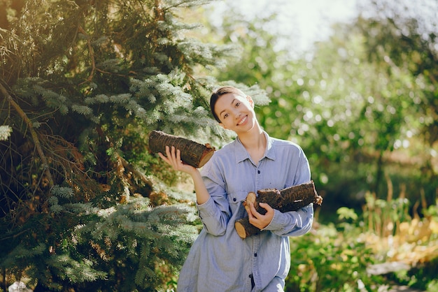 Girl in a blue shirt standing on trees