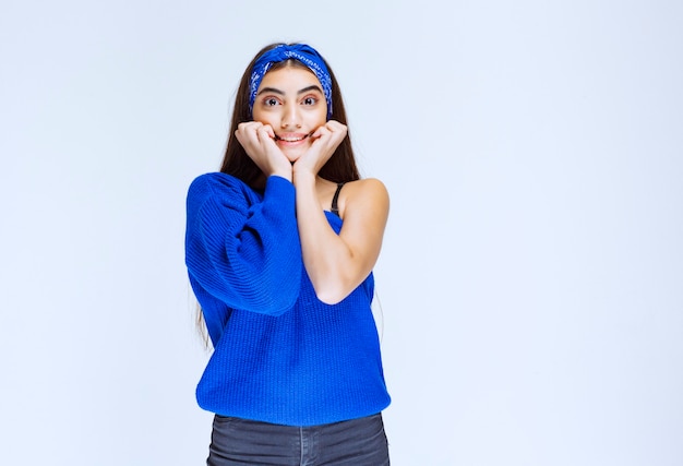 Girl in blue shirt thinking and analyzing.