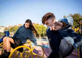 Free photo girl and boy spending time together in the park outside