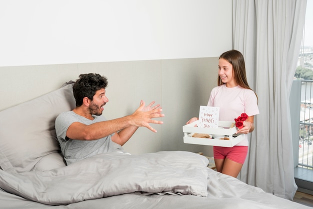Girl brings breakfast on fathers day
