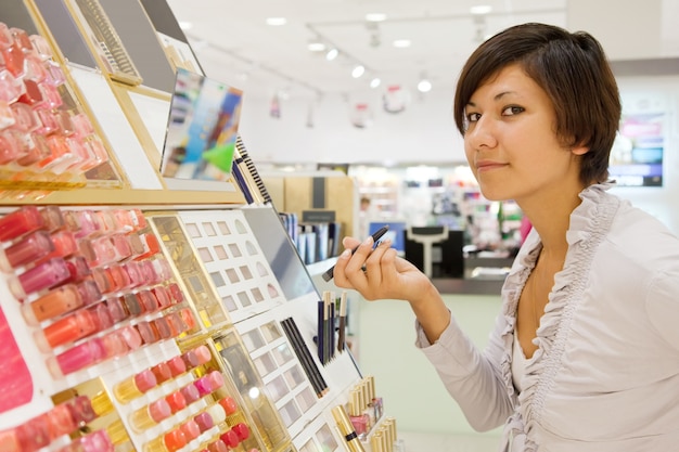 Free photo girl buying cosmetic