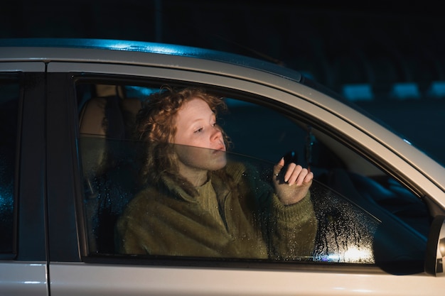 Free photo girl in car at night