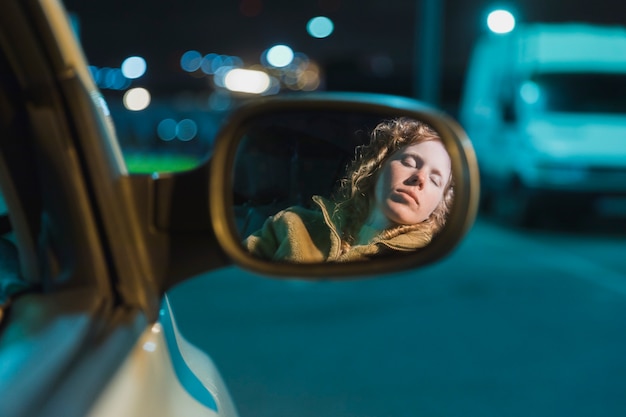 Girl in car at night