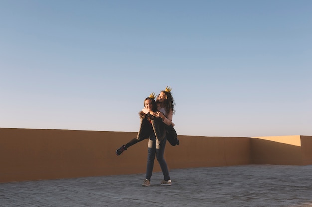 Girl carrying friend on back