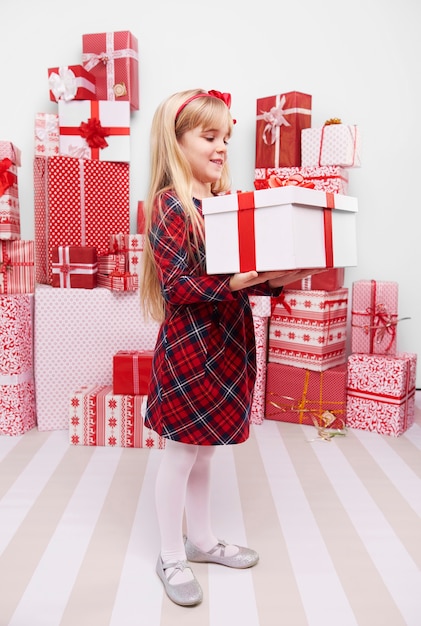 Girl carrying heavy Christmas present