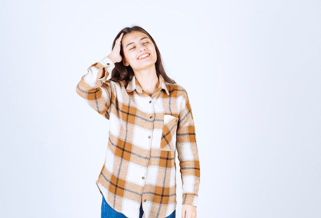 Free photo girl in casual clothes feeling pleased on white wall.