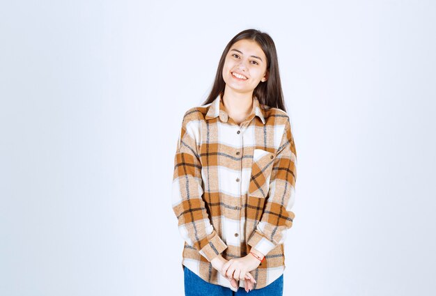  girl in casual clothes posing on white wall. 