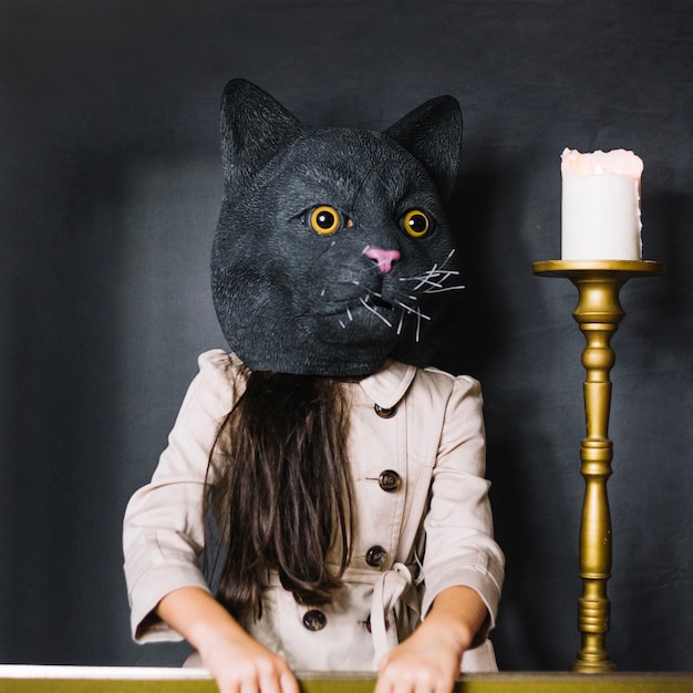 Free photo girl in cat mask and candle