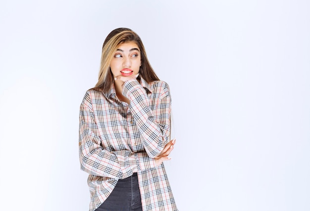 Free photo girl in checked shirt looks scared and terrified