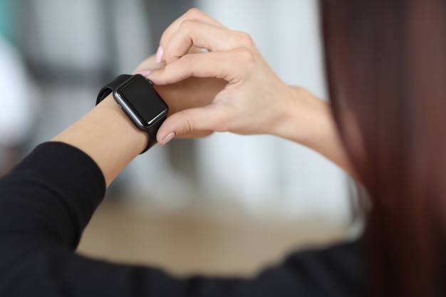 Girl checking the time on her watch